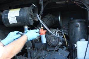 A person is holding an air compressor and some other tools